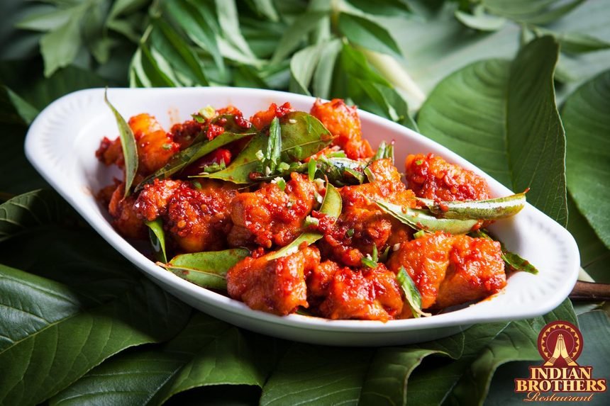 Chilli chicken, crisp-fried and tossed with curry leaves in a fiery red glaze