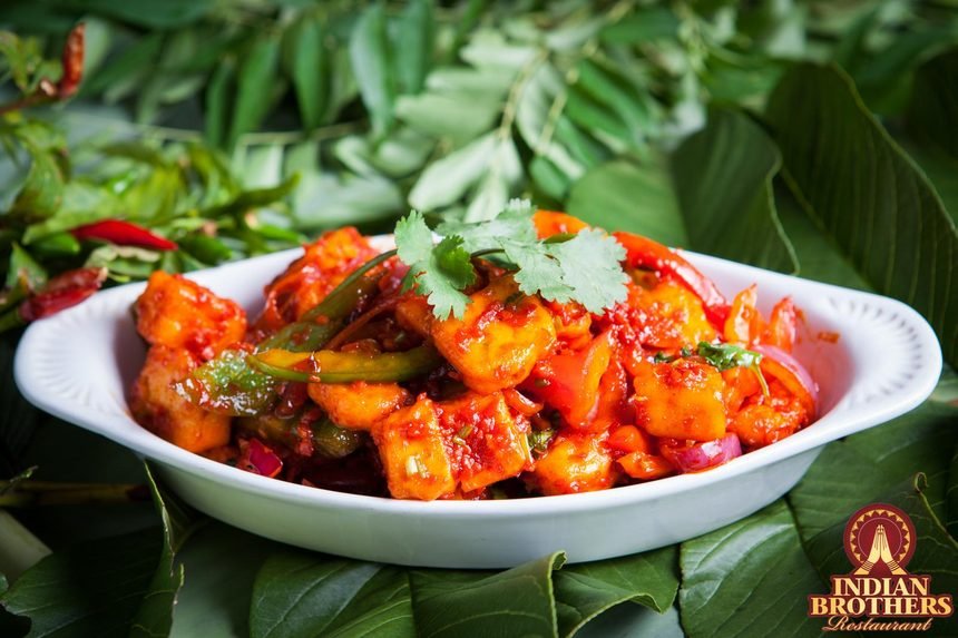 Chilli paneer with capsicum and onion in a sticky red glaze